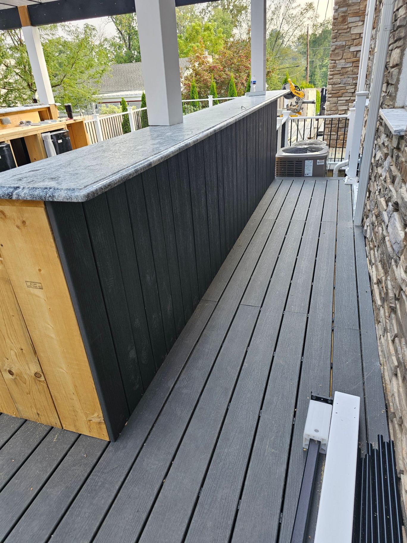 Outdoor bar with granite countertop on composite deck
