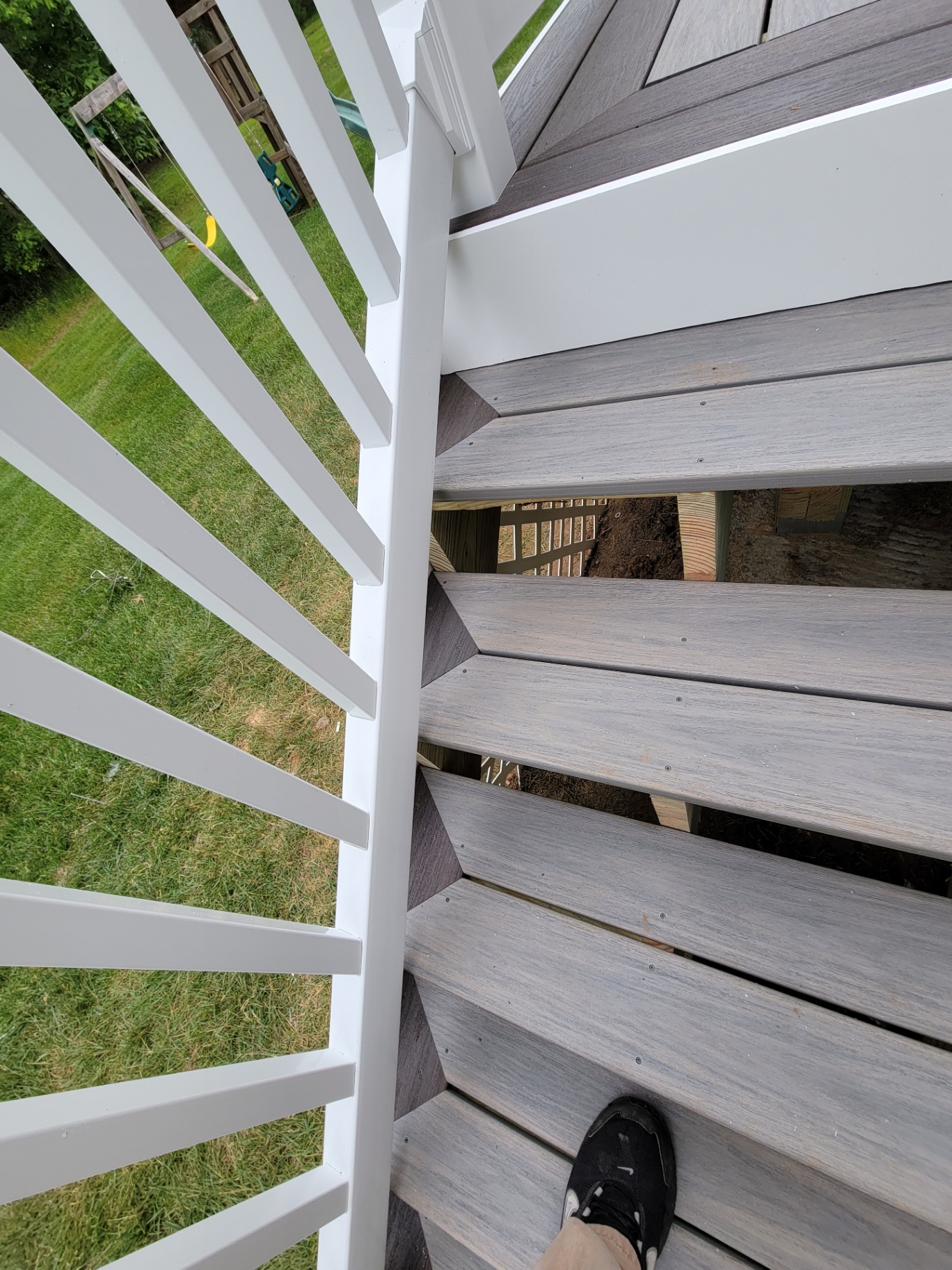Overhead view of composite deck stairs and white railings