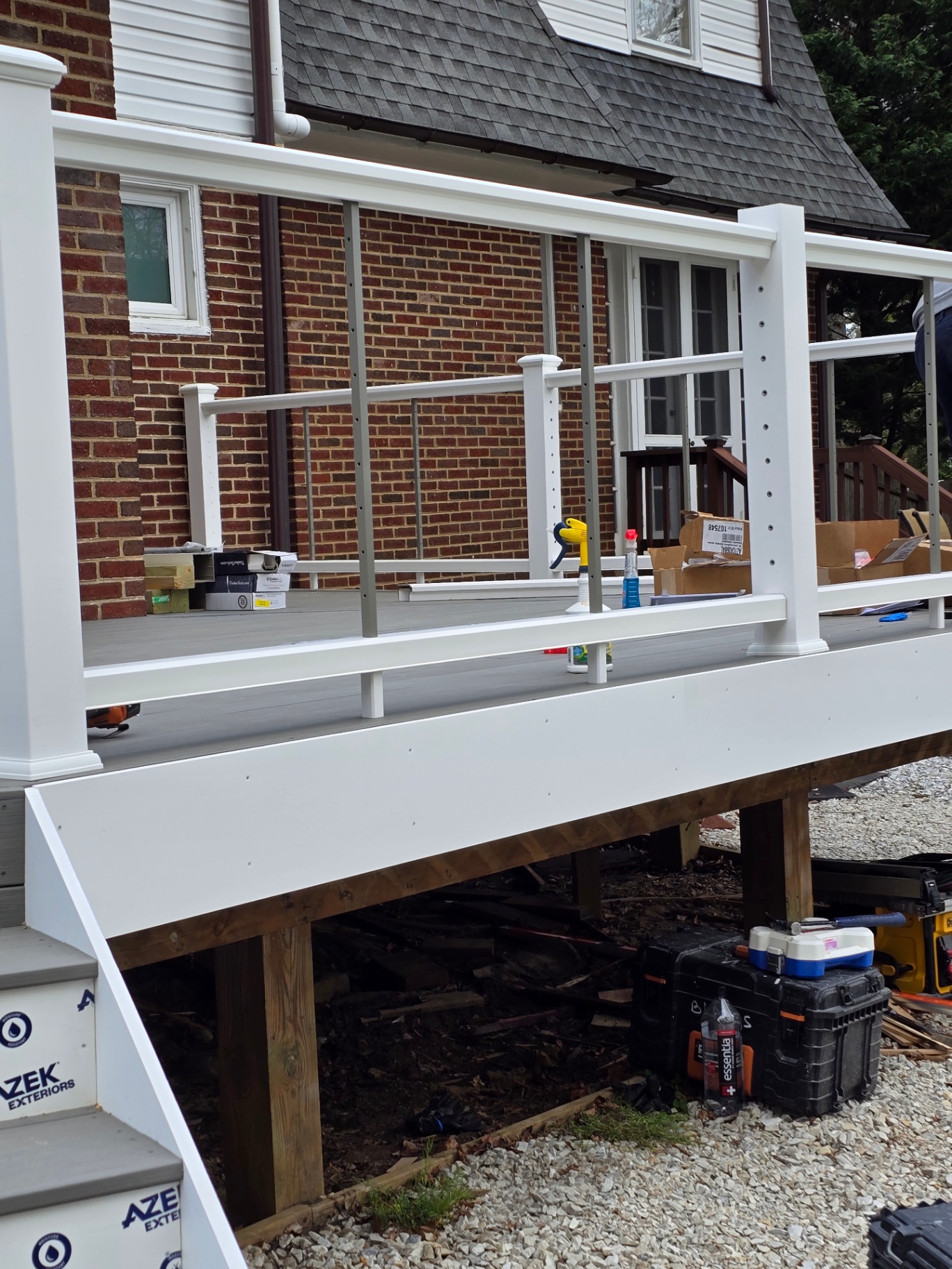 Close-up of white cable railings with gray composite decking