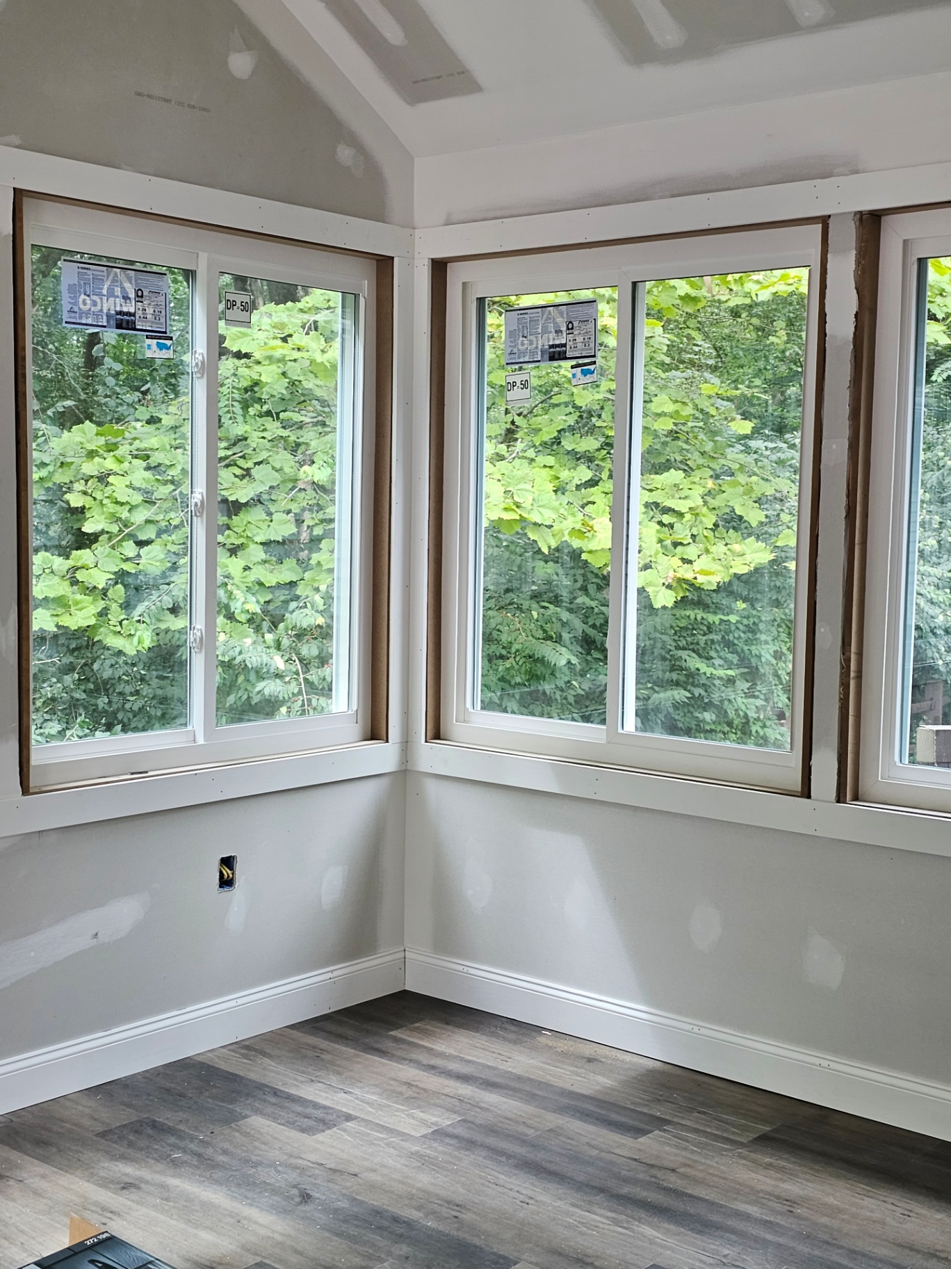 Sunroom windows overlooking wooded backyard